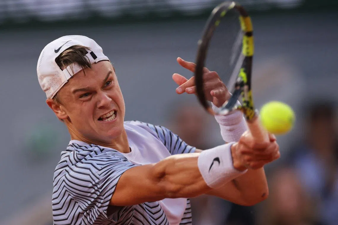 Denmark's Holger Rune plays a forehand return to Norway's Casper Ruud during their French Open quarter-final.