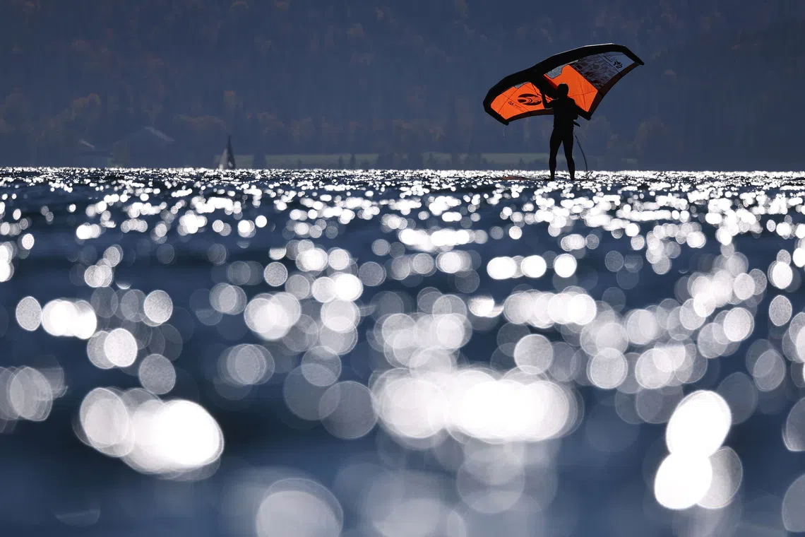 A windsurfer enjoying the sunny autumn weather at lake Walchensee in Bavaria, southern Germany, on Oct 15, 2025. 