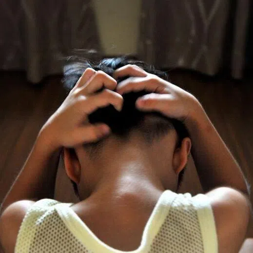 Posed photo of a young boy being tortured. [Generic photo for family violence, child abuse, stress]