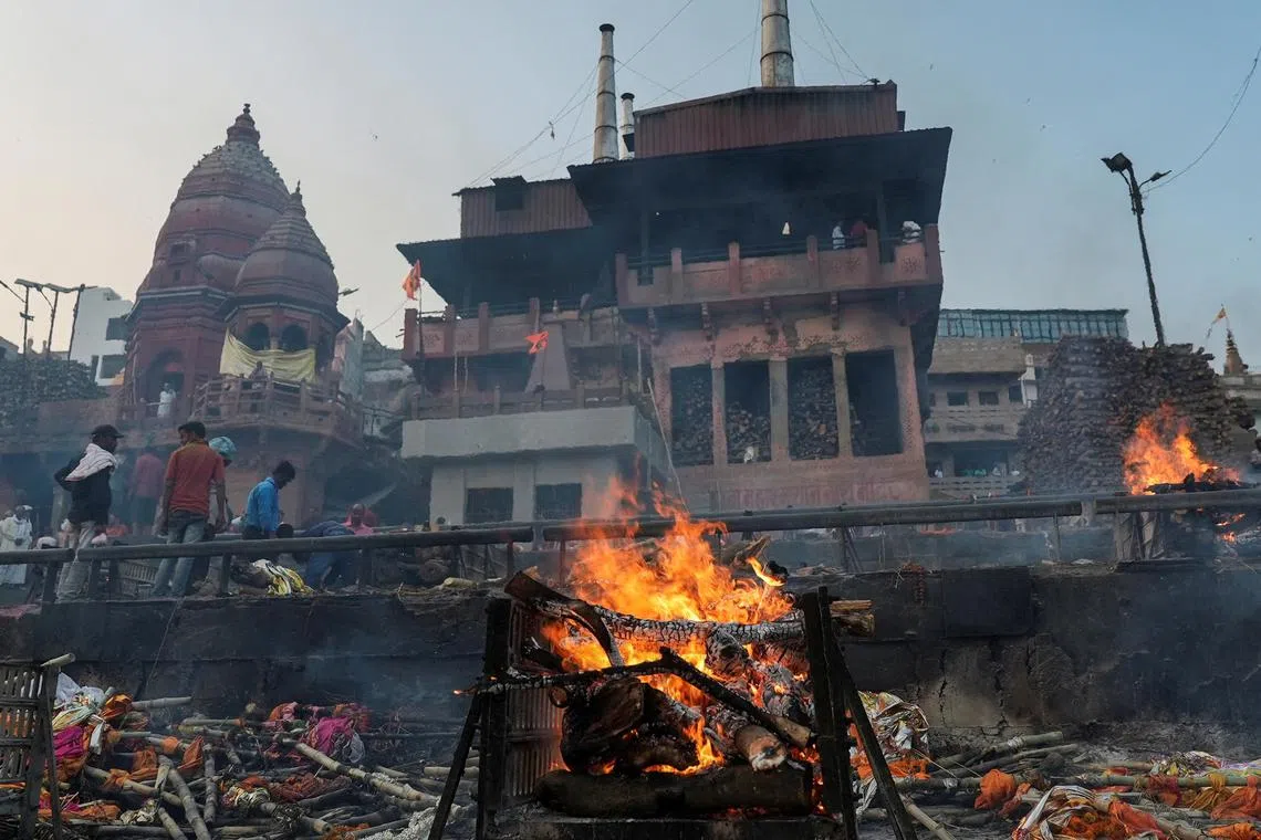 Fires burn at Manikarnika Ghat, an ancient crematorium lying on the shores of the Ganges, in Varanasi, India, March 8, 2023. REUTERS/Joseph Campbell