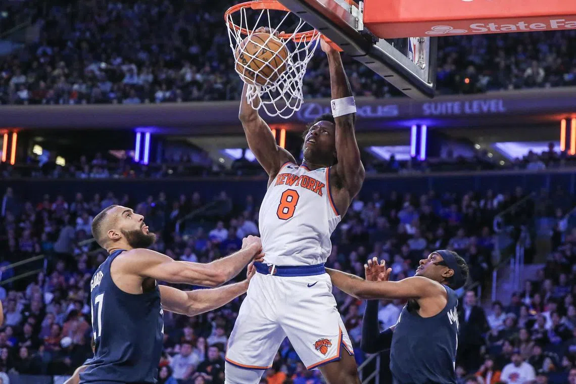 New York Knicks forward OG Anunoby dunks past Minnesota Timberwolves centre Rudy Gobert in the third quarter at Madison Square Garden.
