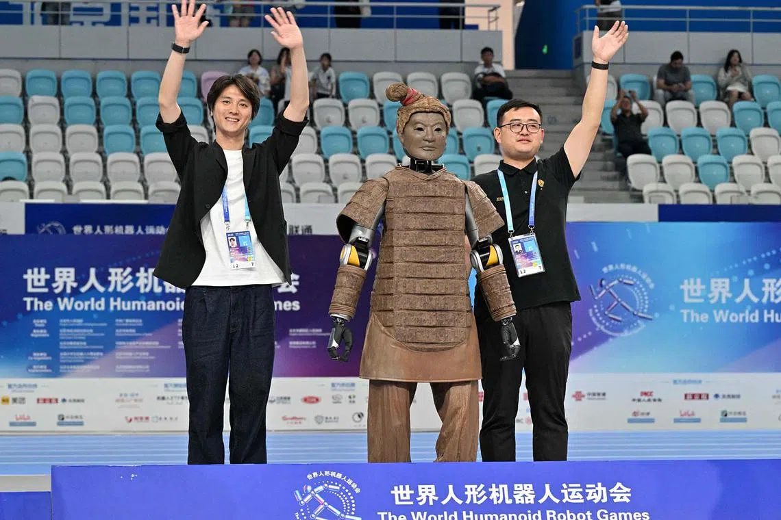 Winner of the dance event from Beijing Dance Academy and Hubei Optics Valley Dongzhi celebrating during the award ceremony at the World Humanoid Robot Games in Beijing on Aug 15, 2025. 