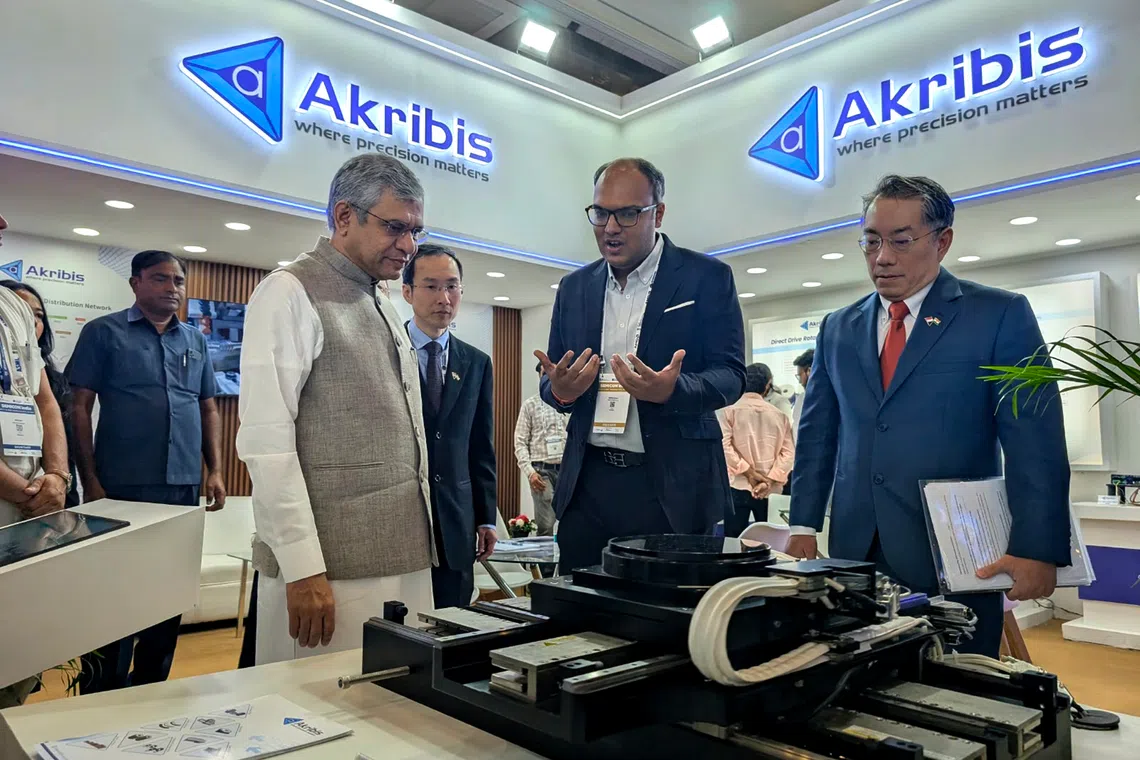 Indian Minister of Electronics and Information Technology Ashwini Vaishnaw visiting the booth of Akribis Systems Pte Ltd, a Singaporean firm that exhibited at the SEMICON India 2026 summit.