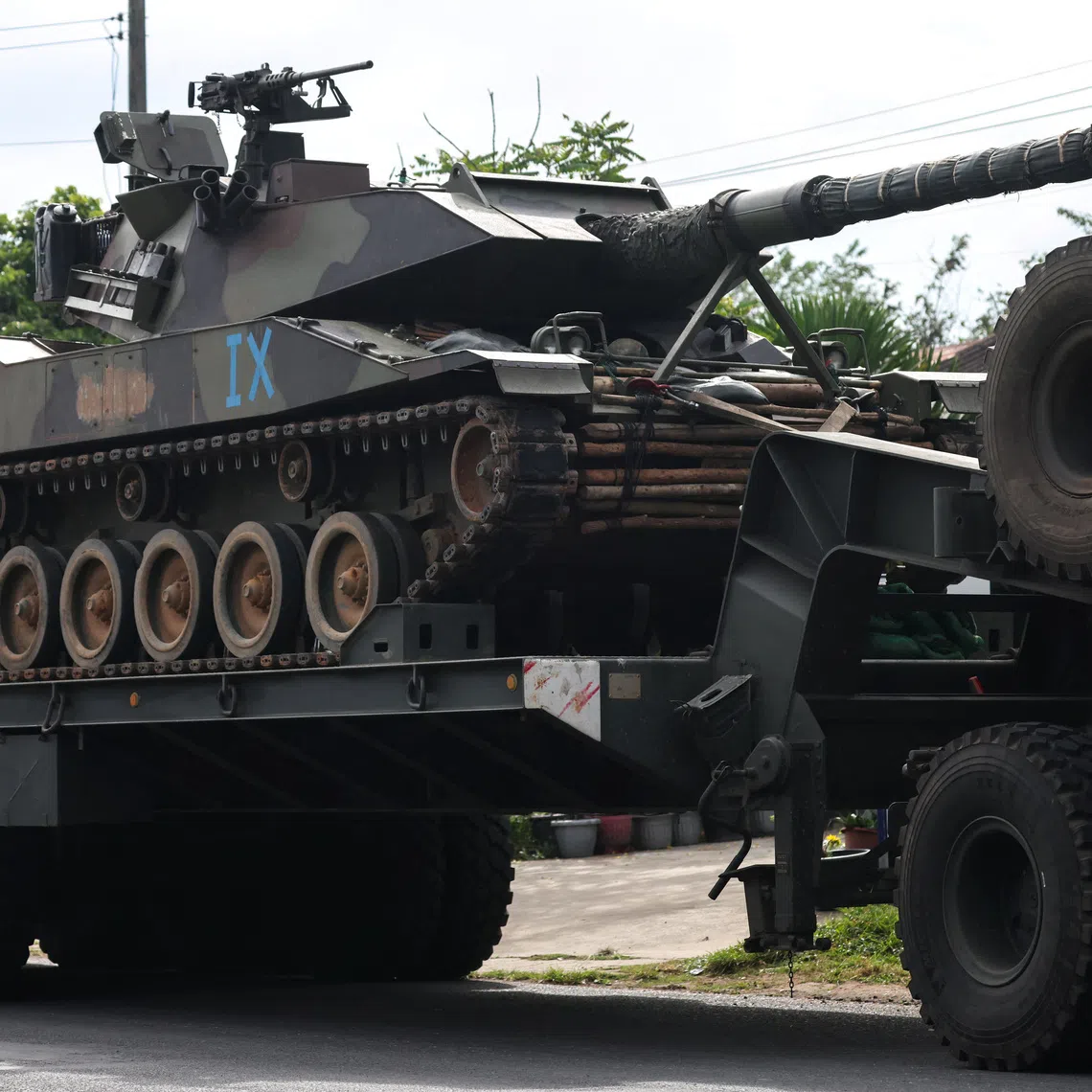 A military truck carries a tank on a road amid deadly clashes between Thailand and Cambodia along a disputed border area, in Surin province, Thailand, December 11, 2025. REUTERS/Athit Perawongmetha