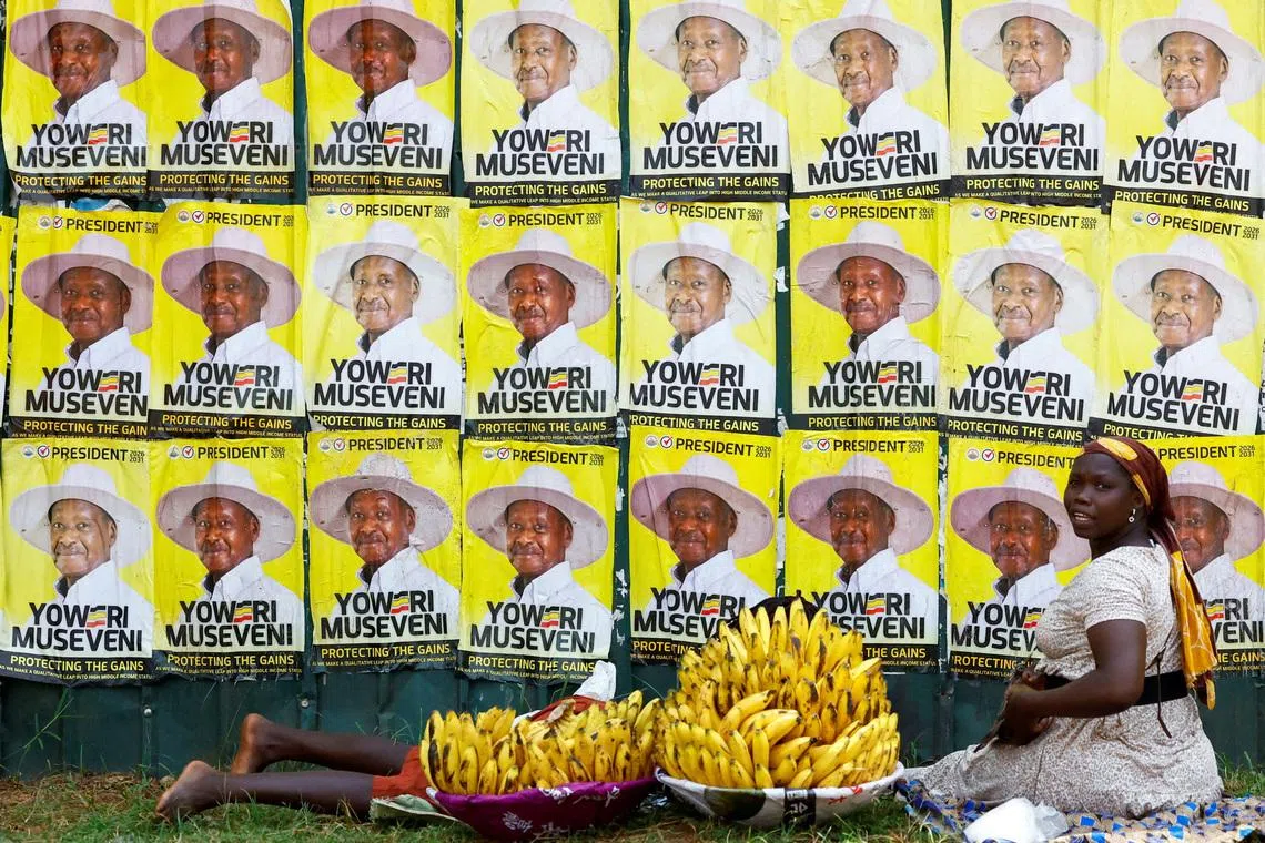 Women sell bananas near campaign posters of Uganda's President and the leader of ruling National Resistance Movement (NRM) party, Yoweri Museveni, following the general elections in Kampala, Uganda January 17, 2026. REUTERS/Thomas Mukoya