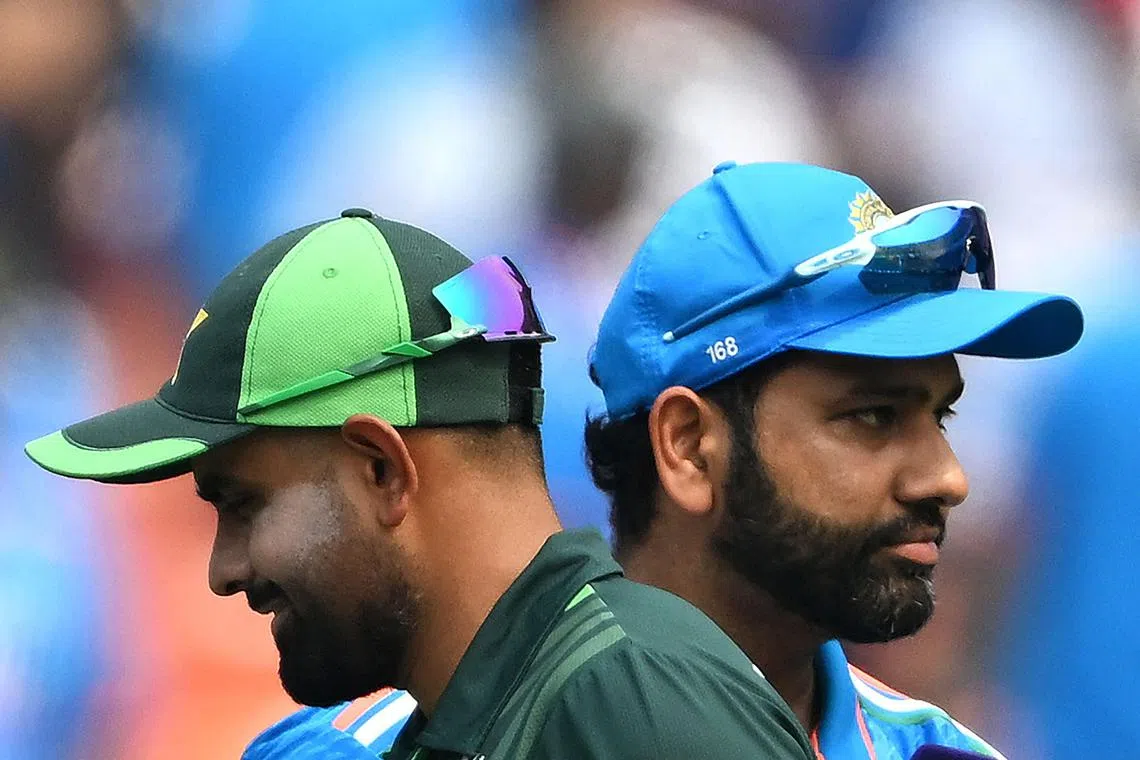 India captain Rohit Sharma and his Pakistan counterpart Babar Azam before the toss for the 2023 ICC Men's Cricket World Cup match at the Narendra Modi Stadium in Ahmedabad on Oct 14, 2023.