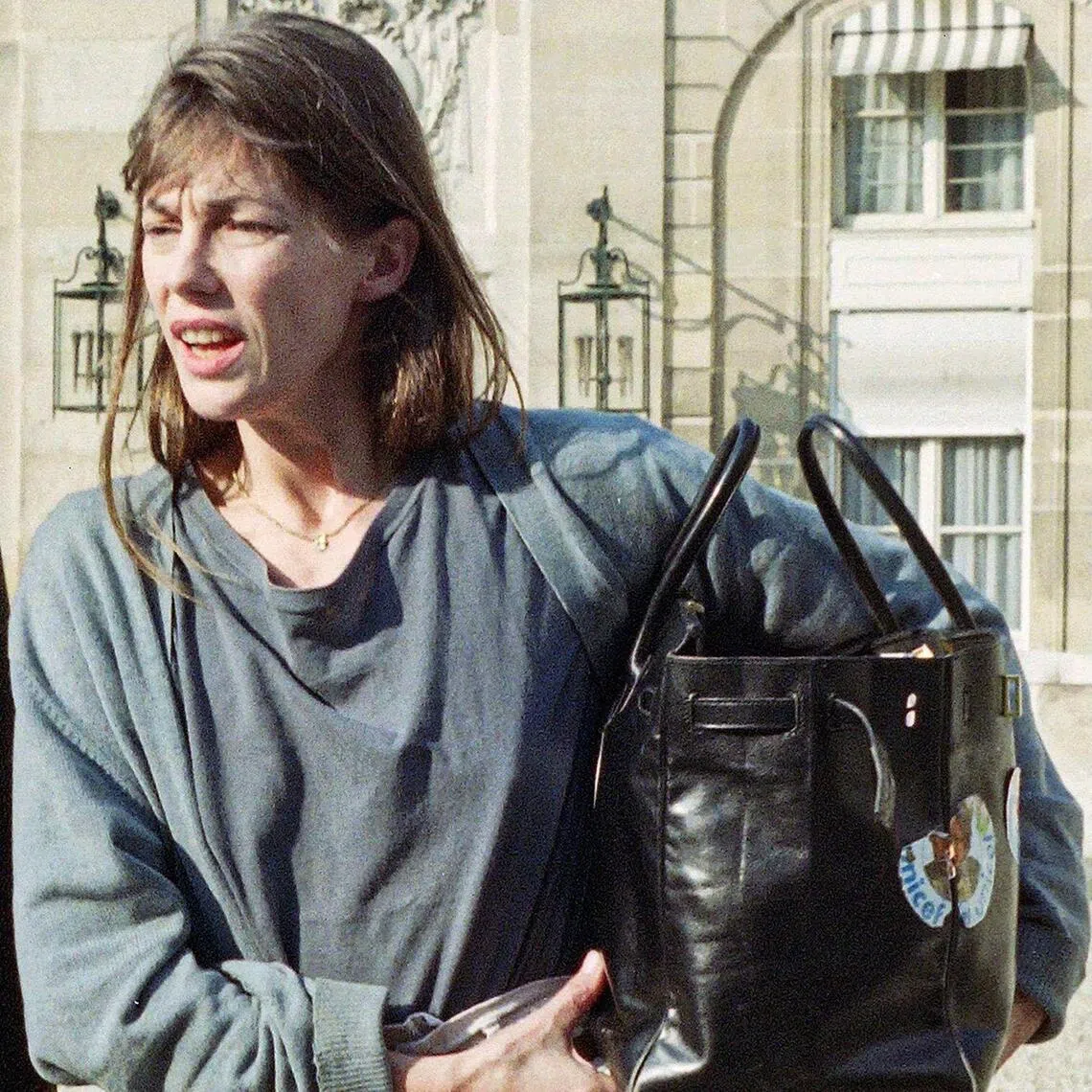 The "Birkin" bag (left) by Hermes which belonged to British-French actress and singer Jane Birkin (right) at the Sotheby's auction house.