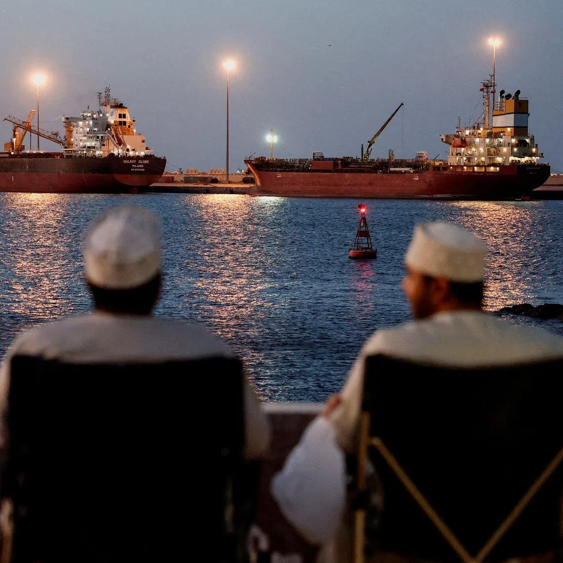 FILE PHOTO: The Galaxy Globe bulk carrier and the Luojiashan tanker sit anchored as Iran vows to close the Strait of Hormuz, amid the U.S.-Israeli conflict with Iran, in Muscat, Oman, March 9, 2026. REUTERS/Benoit Tessier/File Photo