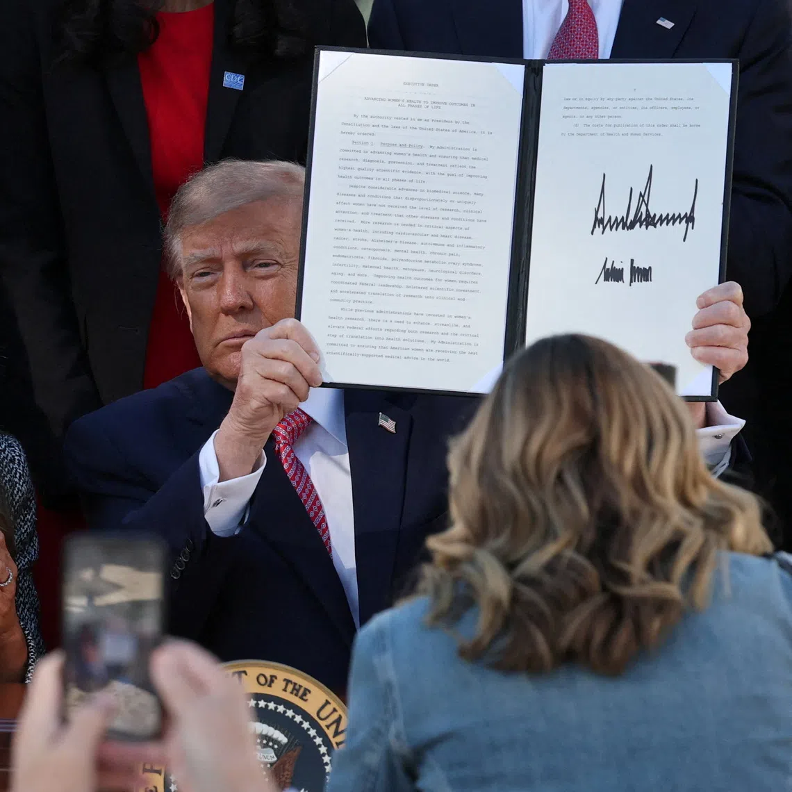 US President Donald Trump presents an executive order on women’s health, spearheaded by first lady Melania Trump, at the White House in Washington DC.