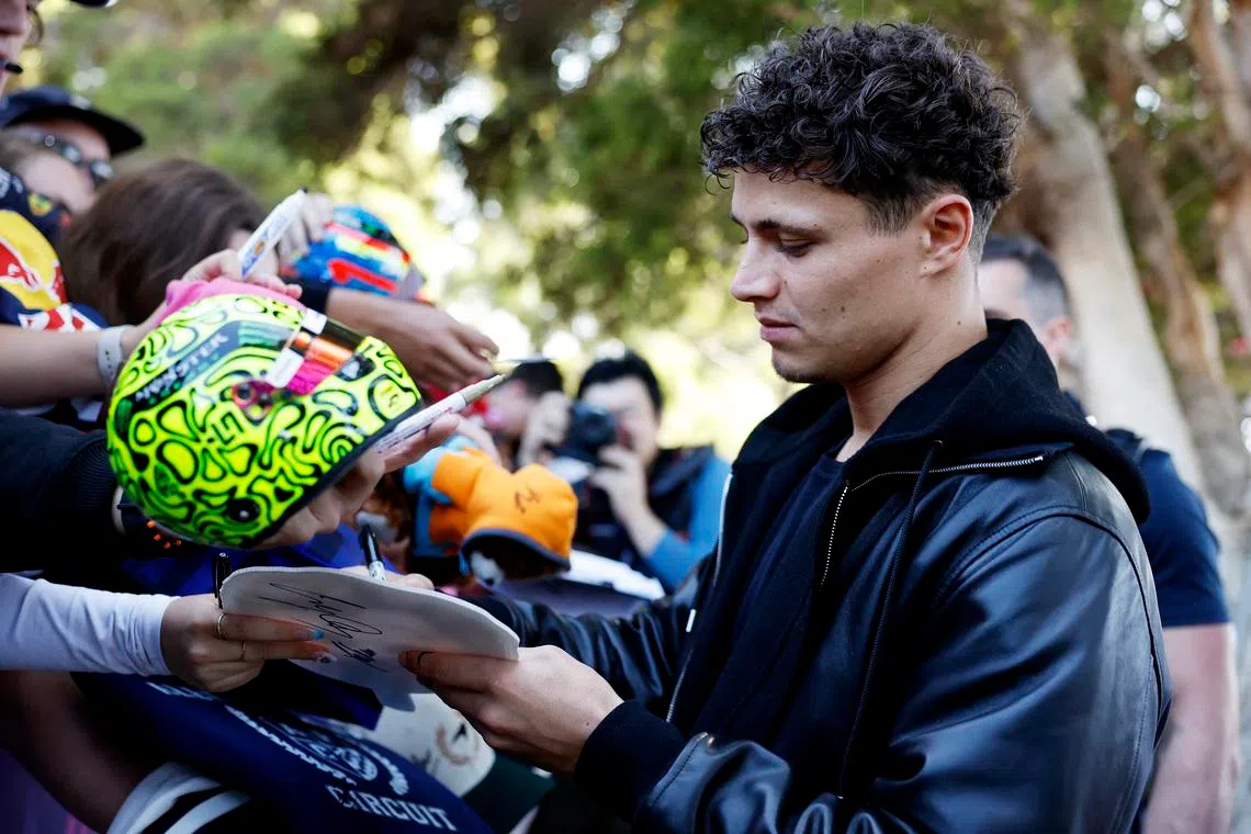 Formula One F1 - Australian Grand Prix - Albert Park Grand Prix Circuit, Melbourne, Australia - March 5, 2026 McLaren's Lando Norris signs autographs for fans ahead of the Australian Grand Prix REUTERS/Hollie Adams