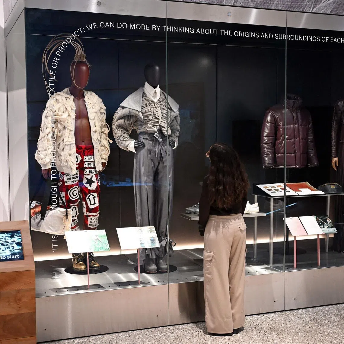 A gallery assistant looks at Ensemble 2021 by Richard Malone on display as part of the The Music Is Black: A British Story exhibition at the V&A East Museum in East London, on April 29, 2026.
