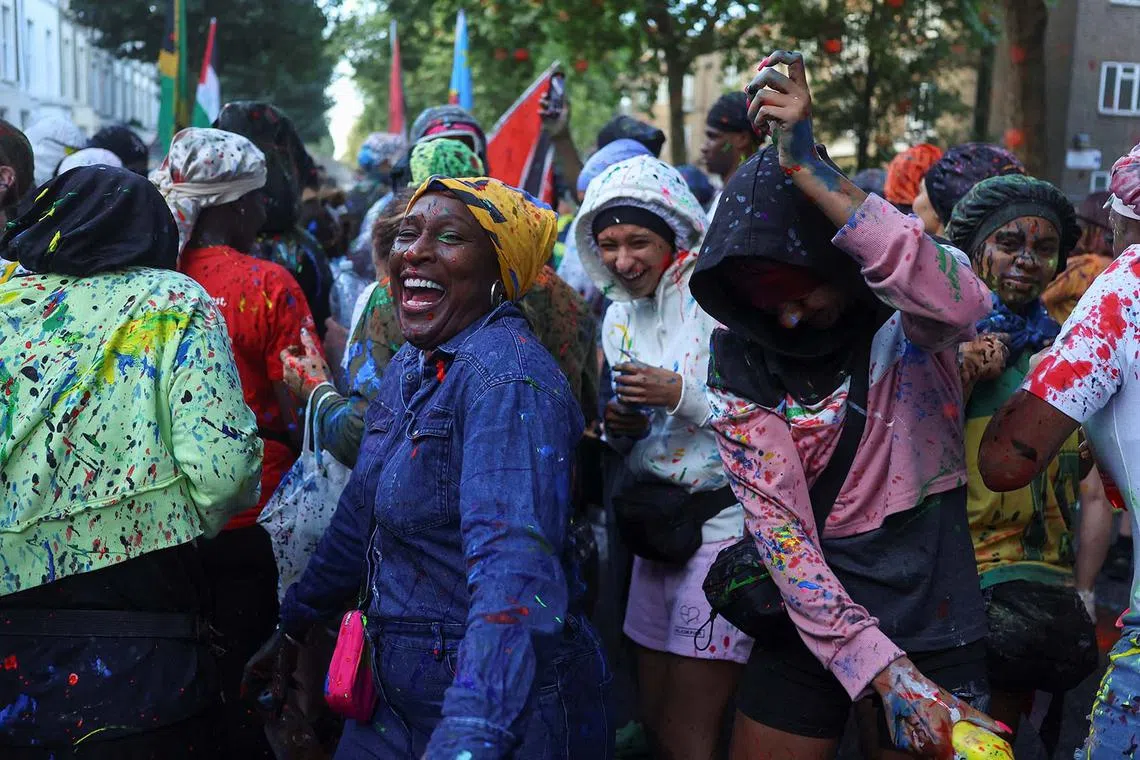 Revellers taking part in the J'Ouvert celebrations at sunrise during Notting Hill Carnival in London, Britain, Aug 24, 2025. 