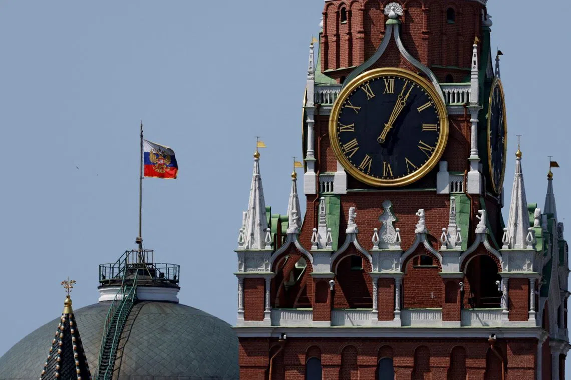 FILE PHOTO: The Russian flag flies on the dome of the Kremlin Senate building behind Spasskaya Tower in Moscow, Russia June 2, 2025. REUTERS/Evgenia Novozhenina/File Photo