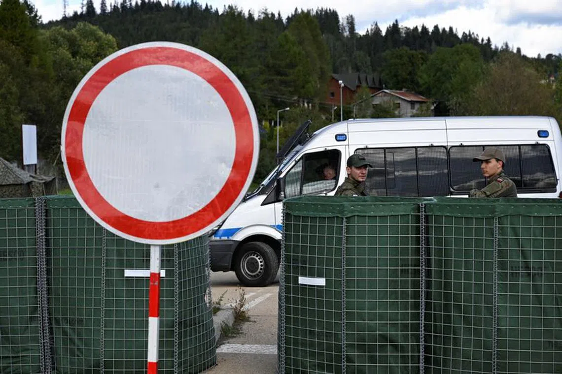 Polish soldiers guard along a temporary checkpoint at the Slovakia-Poland border, as seen from the village Skalite, Slovakia, October 4, 2023. REUTERS/Radovan Stoklasa/File Photo
