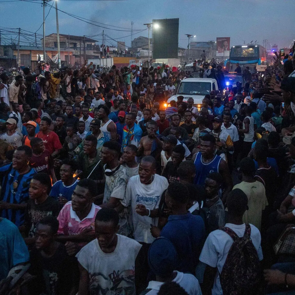 DR Congo supporters celebrate in the streets as they wait for the bus transporting the national soccer team upon their arrival in Kinshasa on Nov 17, 2025.