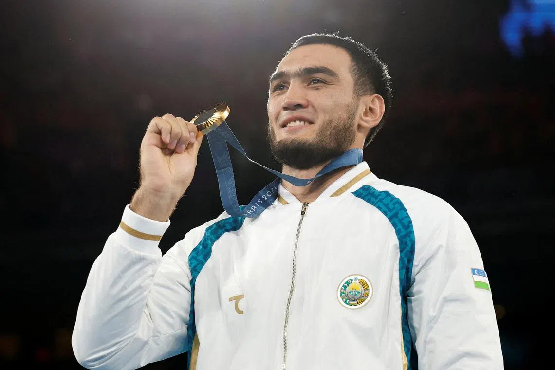 FILE PHOTO: Paris 2024 Olympics - Boxing - Men's 92kg - Victory Ceremony - Roland-Garros Stadium, Paris, France - August 09, 2024. Gold medallist Lazizbek Mullojonov of Uzbekistan poses with his medal. REUTERS/Peter Cziborra/File Photo