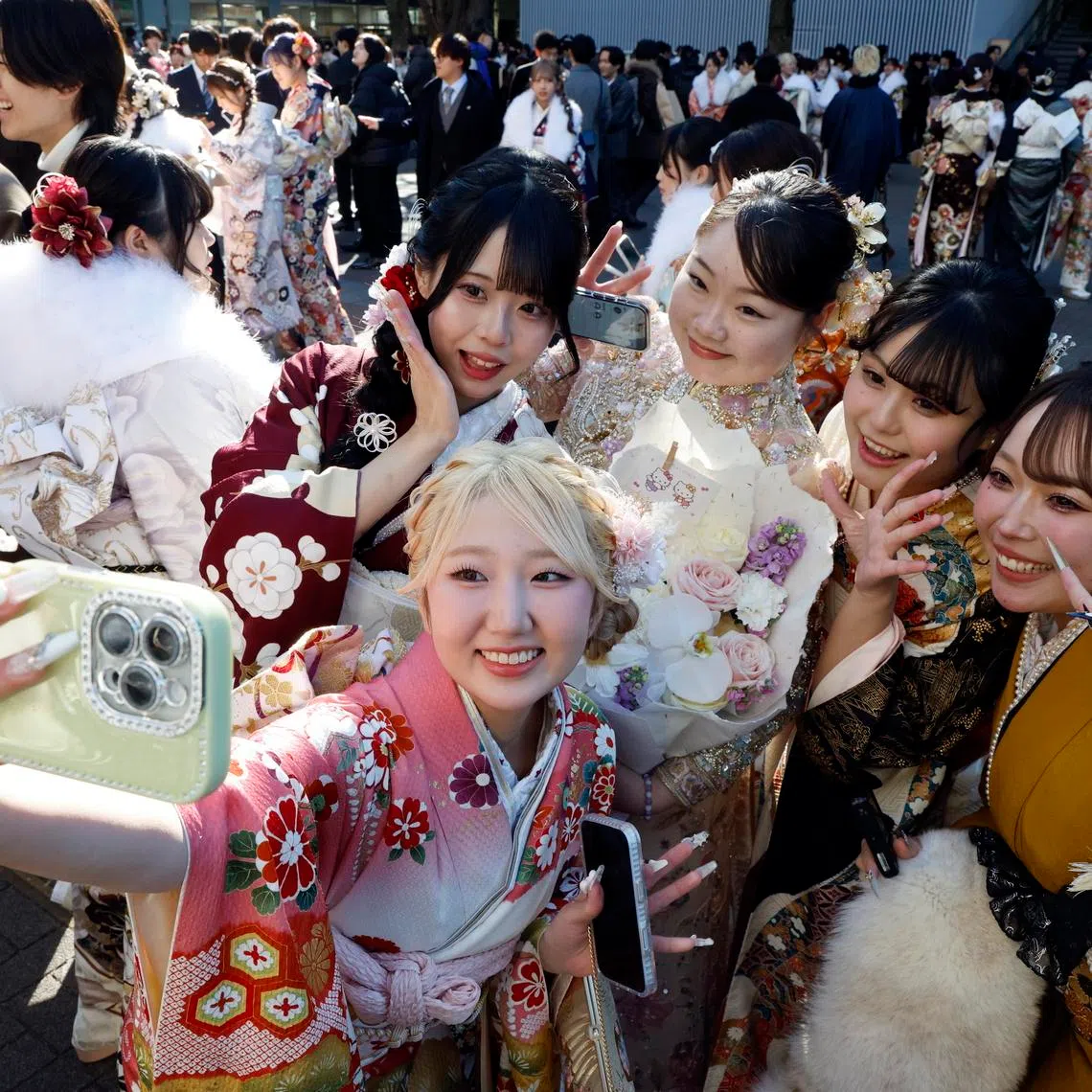 Kimono-clad Japanese young women taking selfies after attending a Coming-of-Age Day ceremony in Yokohama, near Tokyo, Japan, on Jan 12, 2026.