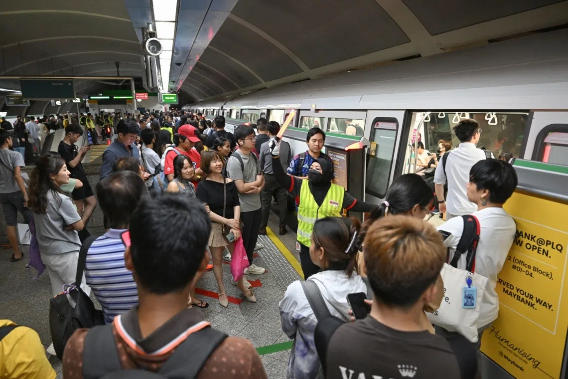 An SMRT employee directing people at Paya Lebar station on Dec 2.