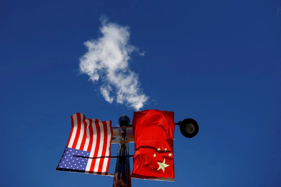 FILE PHOTO: The flags of the United States and China fly from a lamppost in the Chinatown neighborhood of Boston, Massachusetts, U.S., November 1, 2021. REUTERS/Brian Snyder/File Photo