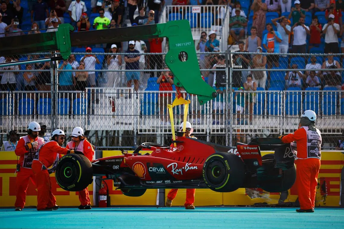 Charles Leclerc's car is removed from the circuit after the Ferrari driver crashed during practice for the Miami Grand Prix on Friday. 