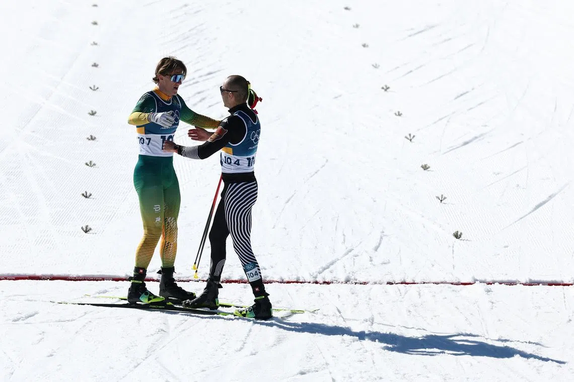 Milano Cortina 2026 Olympics - Cross-Country Skiing - Men's 10km Interval Start Free - Tesero Cross-Country Skiing Stadium, Lago, Italy - February 13, 2026. Matthew Smith of South Africa and Allan Corona of Mexico greet each other after finishing REUTERS/Kacper Pempel