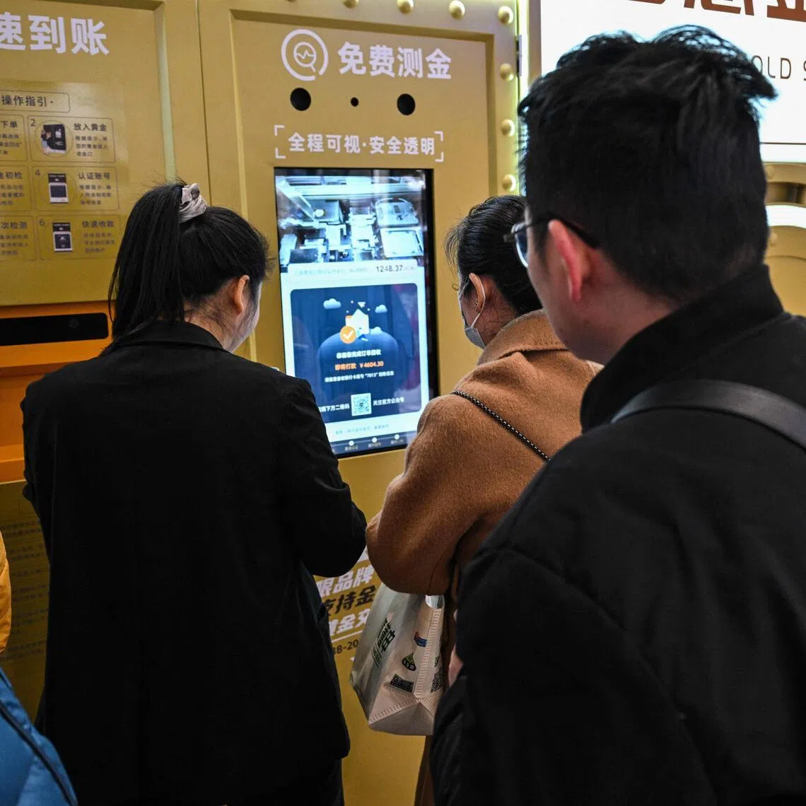Customers wait to sell their gold jewelry in a Smart Gold Store Machine placed in a shopping in Shanghai.