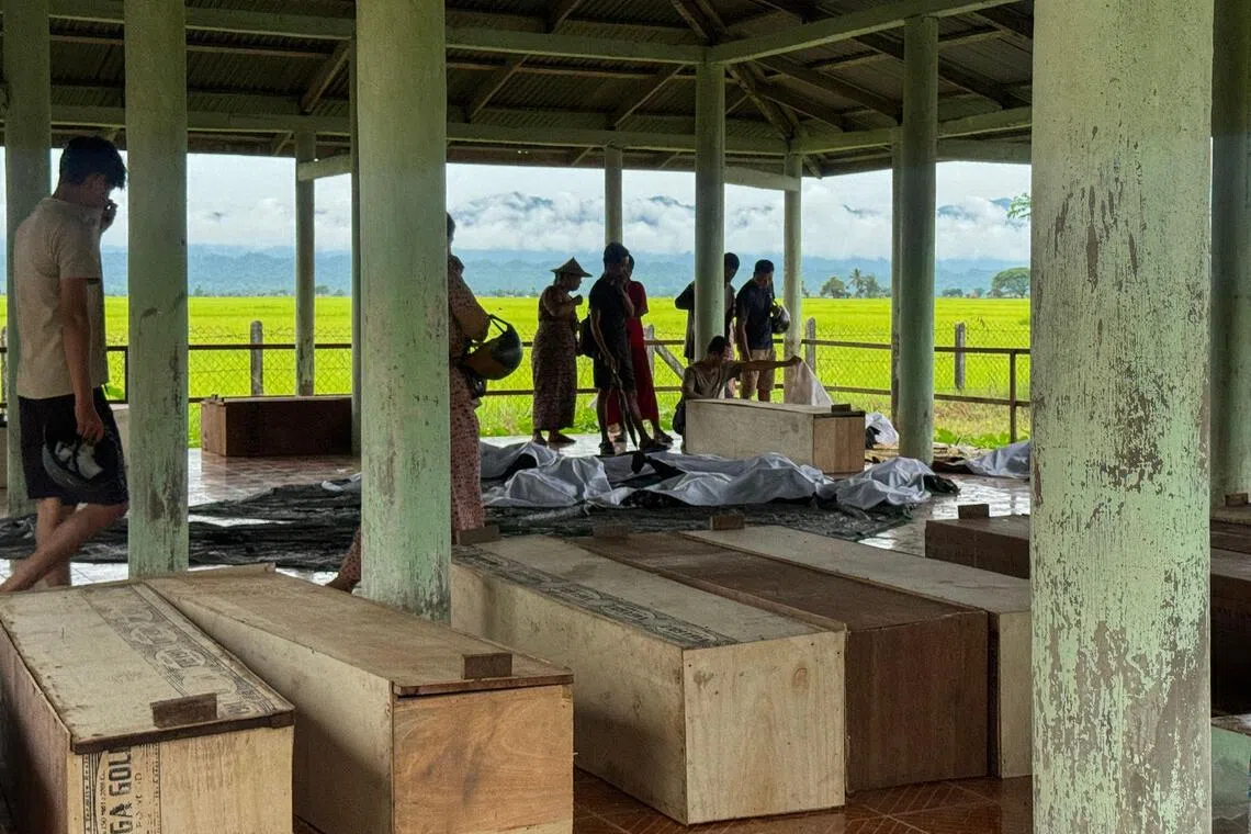 Wooden coffins lined up inside a shelter on Sept 29, as relatives gather to identify the bodies of their loved ones following the airstrike in Kyauktaw town, Rakhine State, a day earlier.