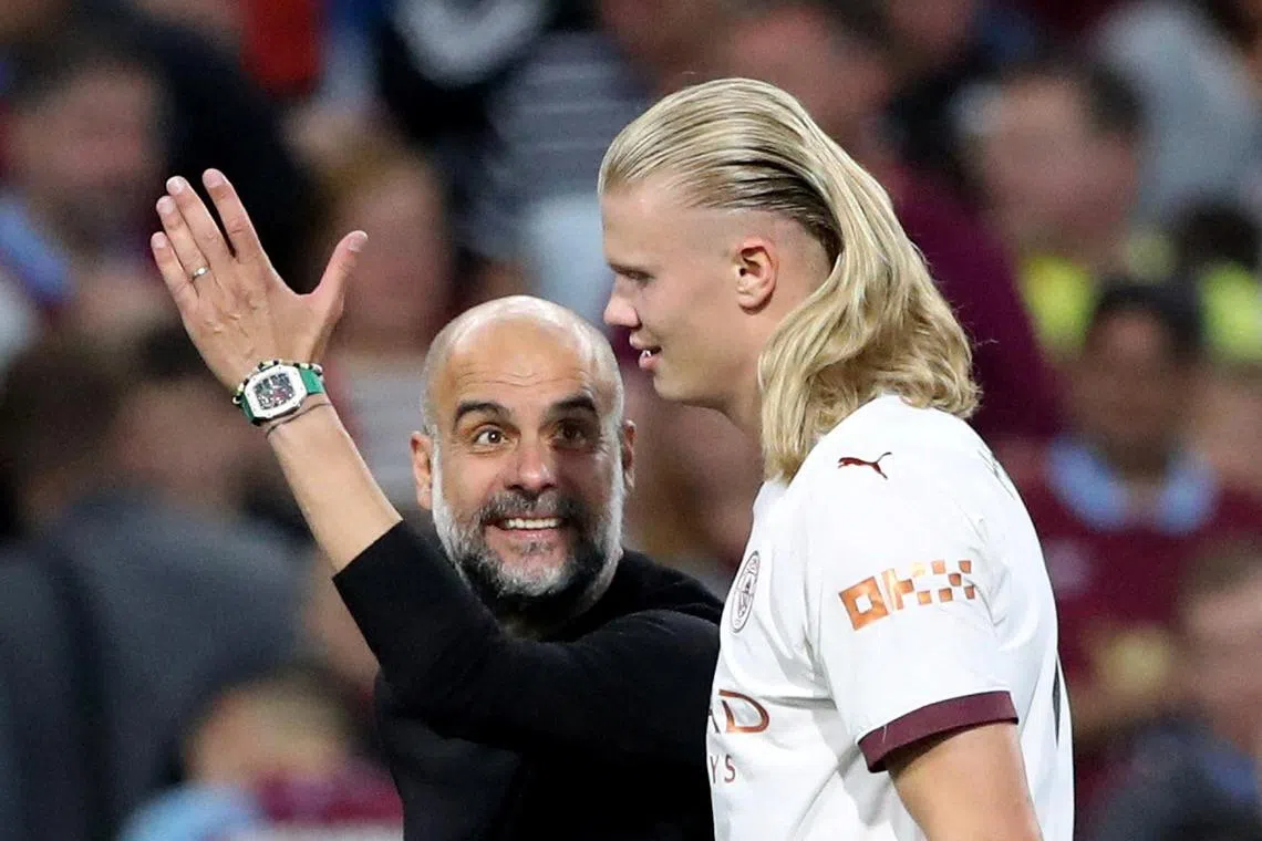 Manchester City's Erling Braut Haaland with manager Pep Guardiola after the match.