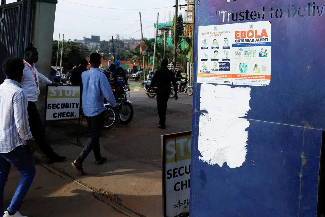 People walk past an advocacy poster against the spread of Ebola virus, as aid agencies intensify efforts to contain a new Ebola outbreak involving the Bundibugyo Virus at the Platinum Medical Centre in Kampala, Uganda May 26, 2026. REUTERS/Abubaker Lubowa