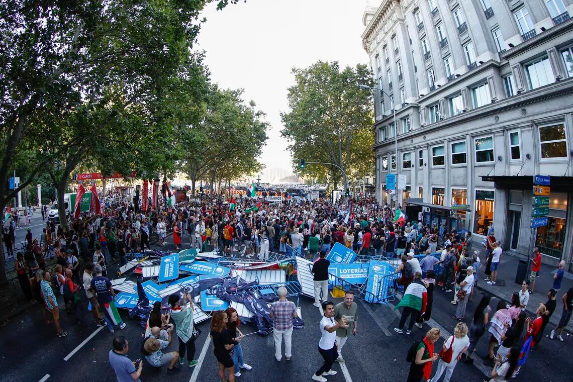 Demonstrators, some holding Palestinian flags, disrupting the cyclists' route on Paseo del Prado during the 21st and last stage of the Vuelta a Espana cycling race, a 103.6km race between Alalpardo and Madrid in Spain on Sept 14, 2025. The 21st stage ended 57km early due to the protest. 