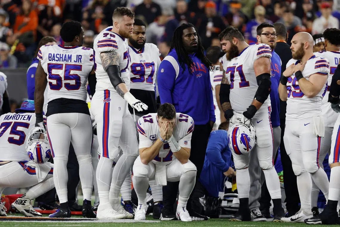 Buffalo Bills players gathering on the field after teammate Damar Hamlin collapsed, at Paycor Stadium in Cincinnati, Ohio, on Jan 2, 2023.