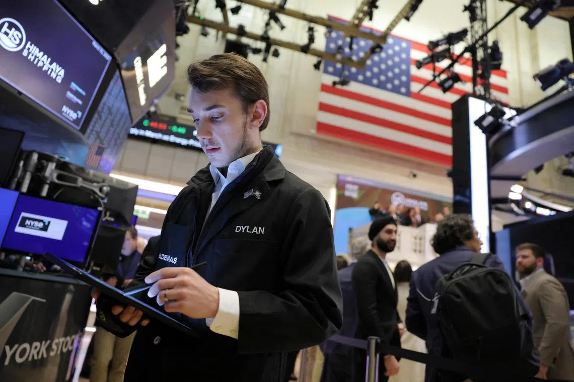 Traders work on the trading floor at the New York Stock Exchange.