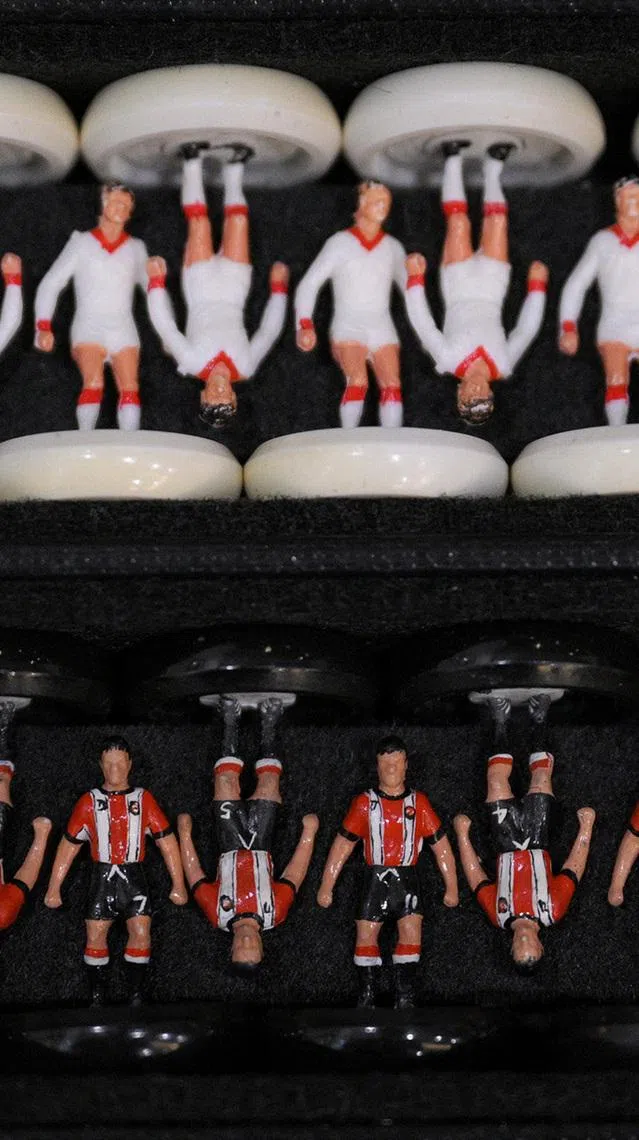 People play Subbuteo, a classic tabletop football game, at a community centre on June 18, 2026.