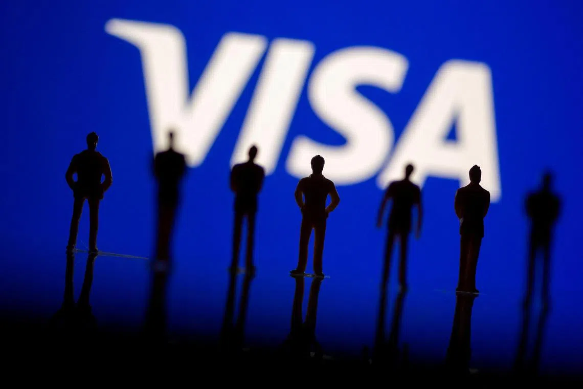 Small toy figures are seen in front of displayed Visa logo in this illustration taken, June 24, 2021. REUTERS/Dado Ruvic/Illustration/File Photo