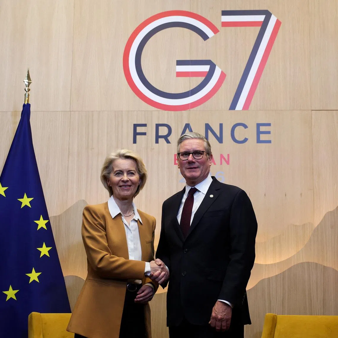 British Prime Minister Keir Starmer and European Commission President Ursula von der Leyen shake hands as they meet, on the sidelines of the G7 summit, in Evian-les-Bains in France, June 16, 2026. REUTERS/Isabel Infantes/Pool