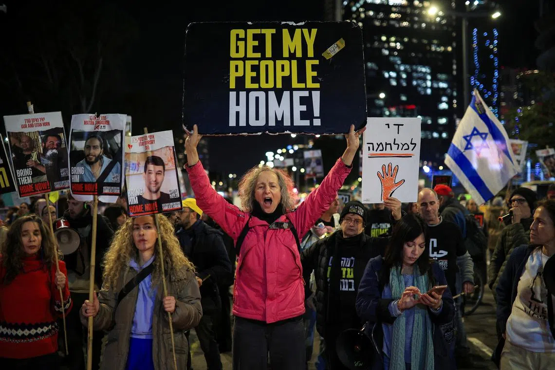 Demonstrators hold signs and pictures of hostages, as relatives and supporters of Israeli hostages kidnapped during the October 7, 2023 attack by Hamas protest demanding the release of all hostages in Tel Aviv, Israel, February 13, 2025. REUTERS/Itai Ron