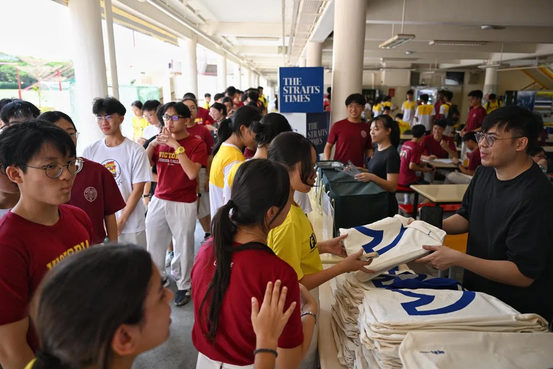 Students collecting a goodie bag containing a copy of The Straits Times and the ST Scholar?s Choice supplement at Victoria Junior College on Feb 21, 2025.