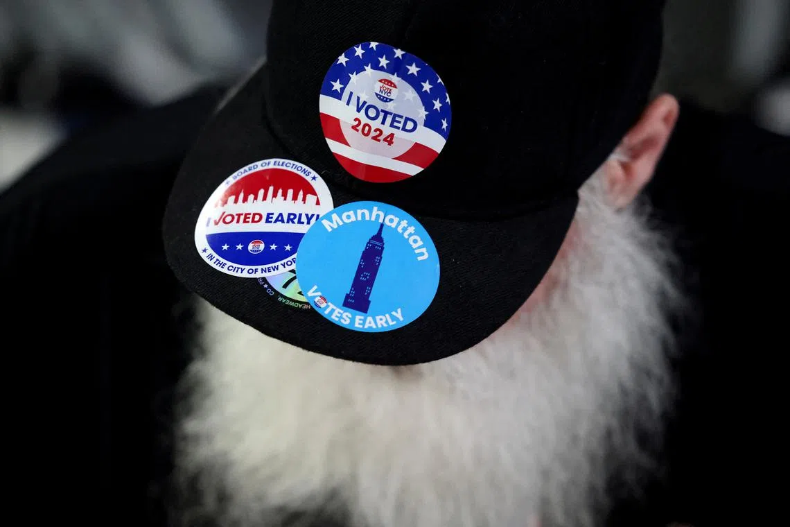 A man wears an hat with stickers, on Election Day for the 2024 U.S. presidential election in Manhattan, New York City, U.S., November 5, 2024. REUTERS/Andrew Kelly