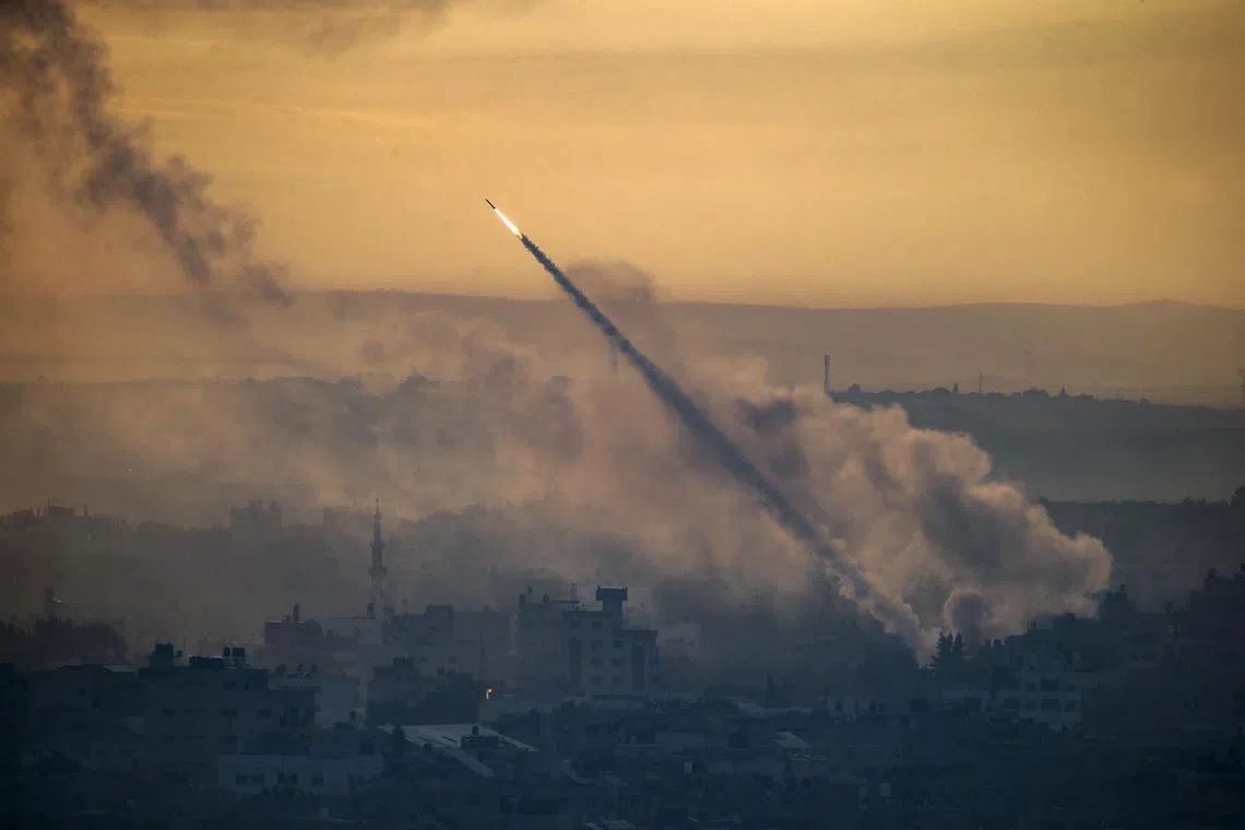 Militants from the military wing of Hamas launch a rocket from the Gaza strip towards Israel.