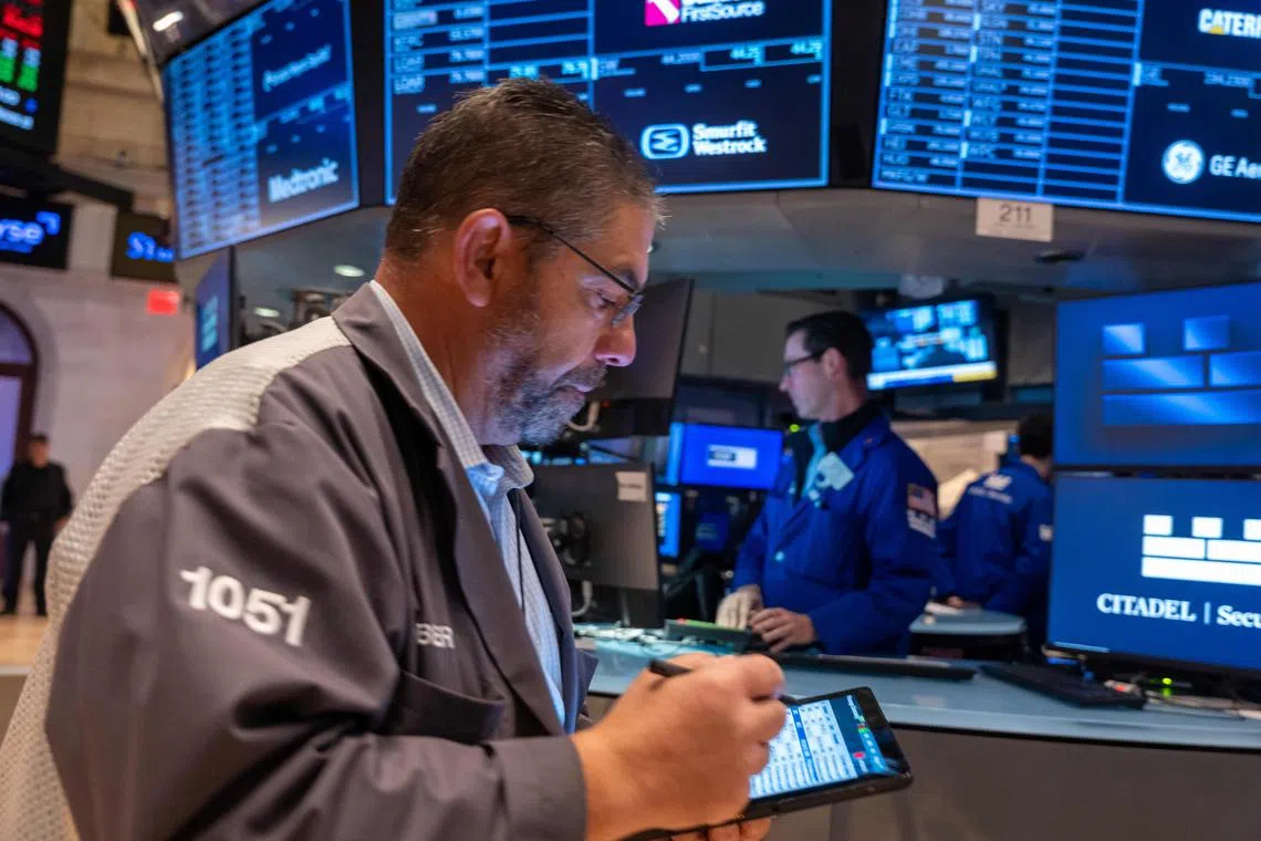 Traders work on the floor of the New York Stock Exchange, on Oct 22, in New York City.
