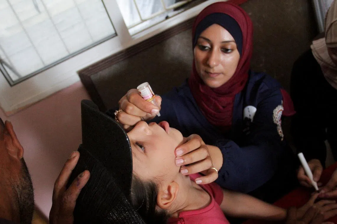 FILE PHOTO: A Palestinian child is vaccinated against polio, amid the Israel-Hamas conflict, in Jabalia in northern Gaza Strip, September 10, 2024. REUTERS/Mahmoud Issa/File Photo