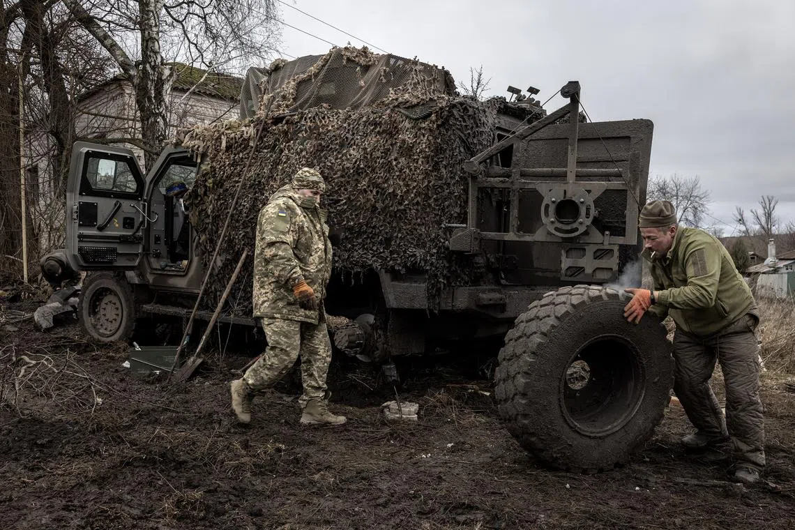 Ukrainian soldiers repaire a vehicle near the border with Russia’s Kursk region on Jan 9.