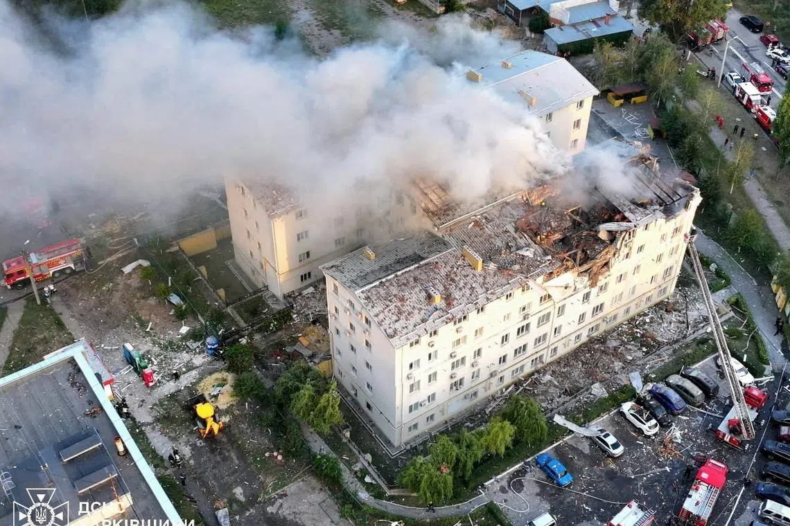FILE PHOTO: Smoke rises from damaged buildings, at the site of the Russian drone strike, amid Russia's attack on Ukraine, in Kharkiv, Ukraine in this handout picture released August 18, 2025. Press service of the State Emergency Service of Ukraine in Kharkiv region/Handout via REUTERS /File Photo
