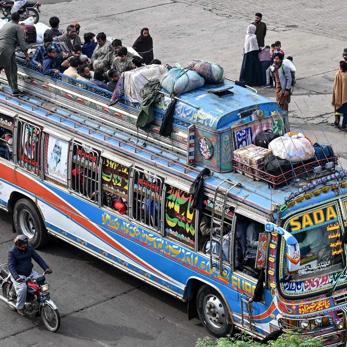 People in Lahore, Pakistan ride an overcrowded bus while returning to their hometowns ahead of Eid al-Fitr.