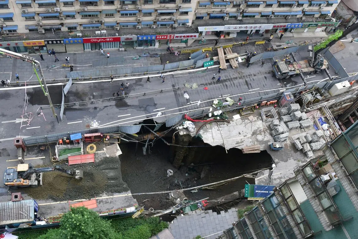 A view of a sinkhole at a road section where a subway construction site collapsed due to burst water pipes, in Chengdu, Sichuan province, China June 21, 2024. China Daily via REUTERS