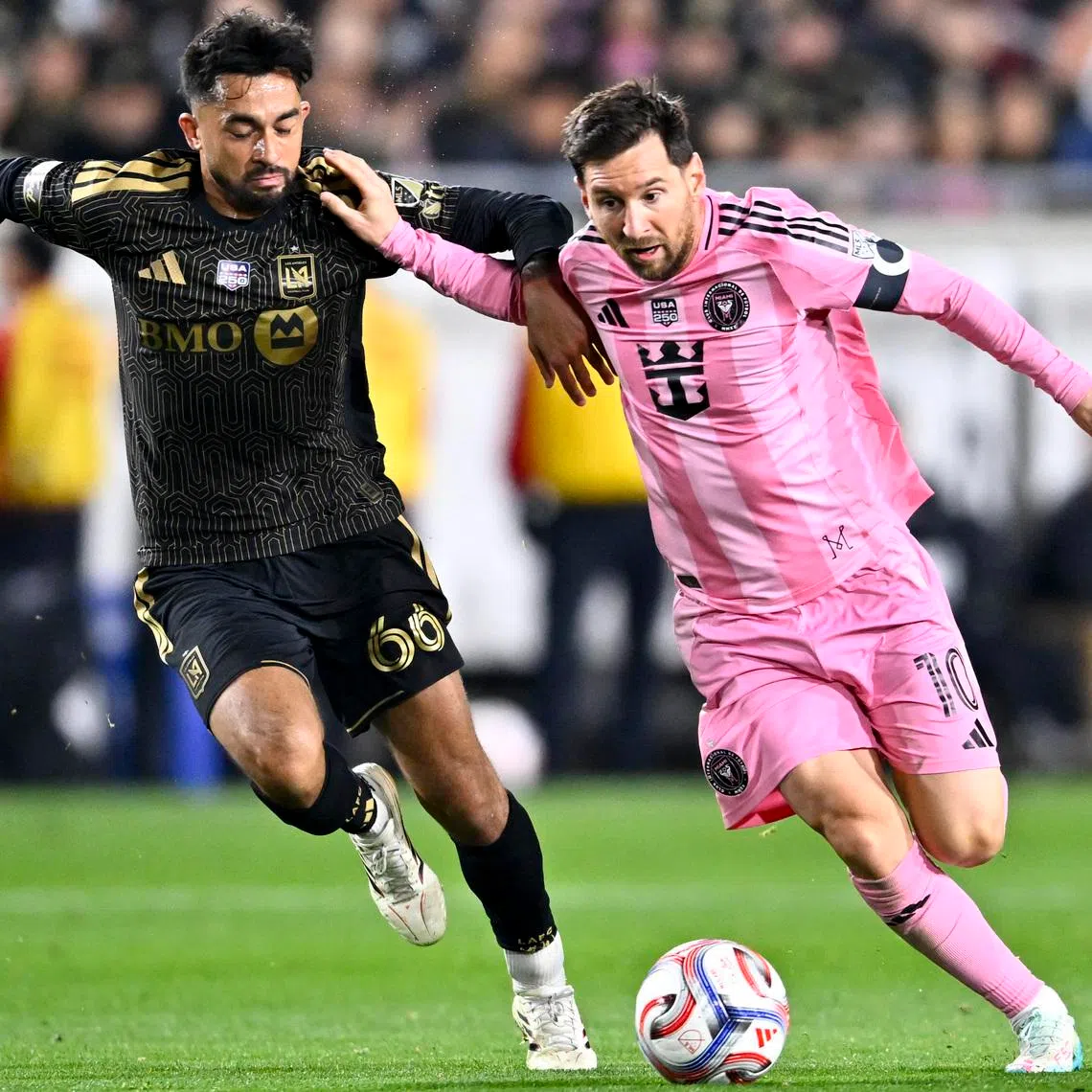 Feb 21, 2026; Los Angeles, California, USA; Inter Miami CF forward Lionel Messi (10) moves the ball against Los Angeles FC midfielder Mathieu Choinière (66) during the second half at Los Angeles Memorial Coliseum. Mandatory Credit: Kelvin Kuo-Imagn Images