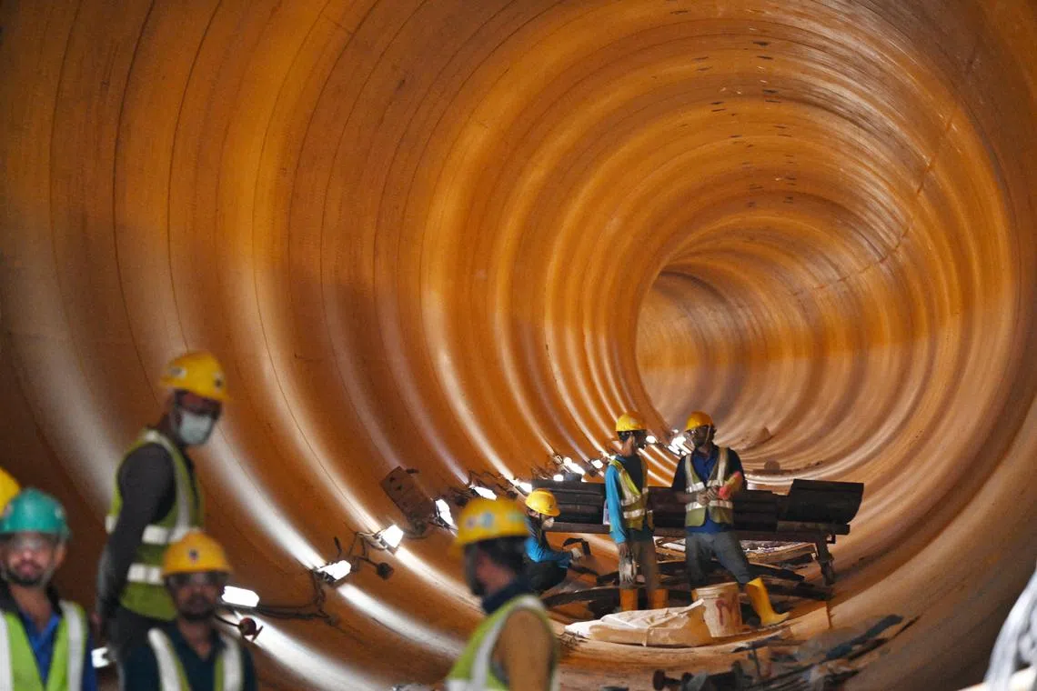 NOTE: EMBARGOED TILL AUG 21.
ST20230817_202350527015 Kua Chee Siong/ ctnwater21/
Construction workers at the completed Deep Tunnel Sewerage System Phase 2 (DTSS2) Tunneling Works at the tunneling site in Penjuru Road on Aug 17, 2023, marking a significant milestone in efforts to transform the country’s used water management system.
Conceived nearly three decades ago, the DTSS is an underground superhighway for used water collection, treatment, reclamation, and disposal. It is also a key pillar in NEWater production, enhancing Singapore’s water resilience against impacts of climate change through the recycling of used water.
Construction of the 100km-long deep tunnels and link sewers for DTSS Phase 2 involved a tremendous amount of preparatory work, deep expertise, and use of cutting-edge technologies.
