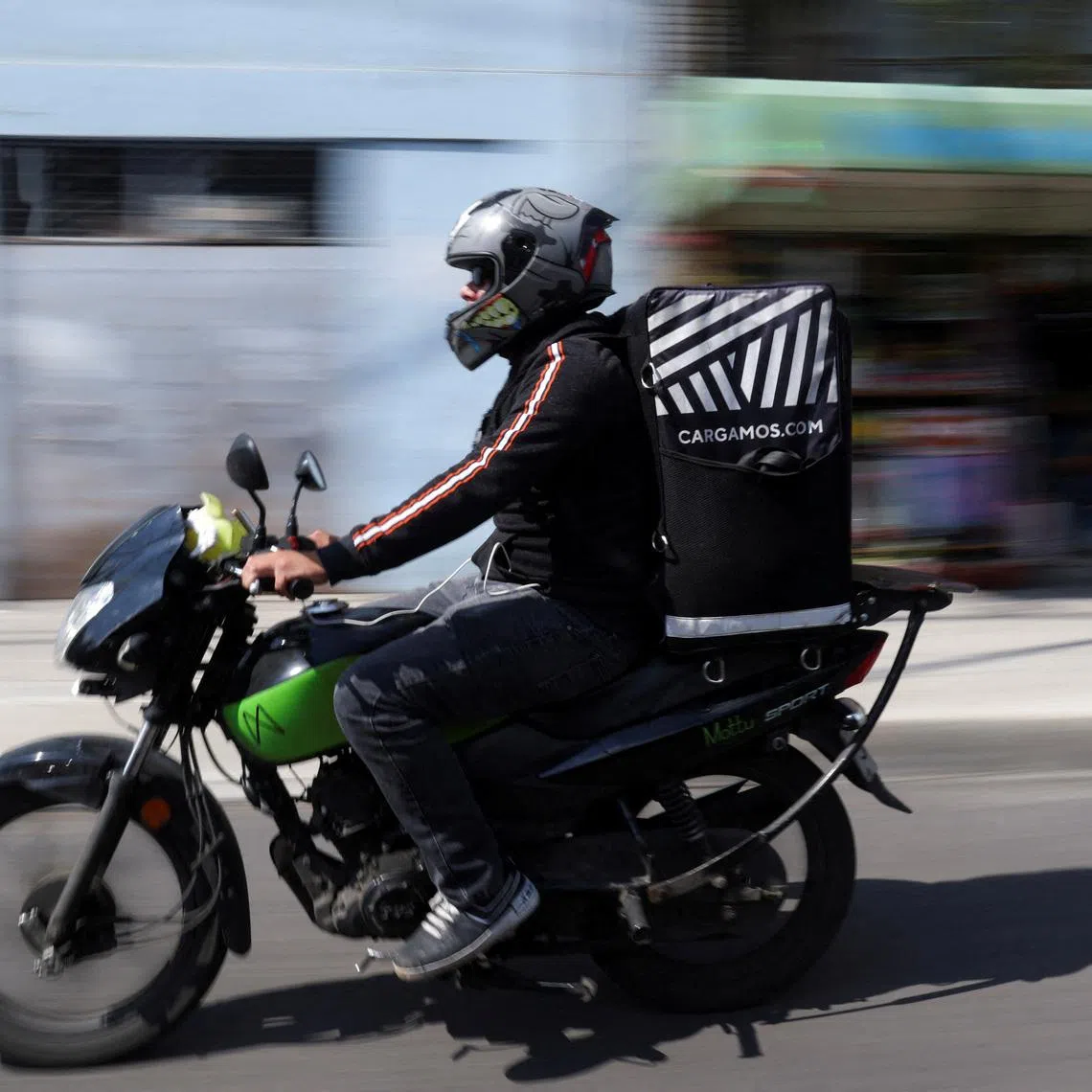 FILE PHOTO: Roberto, a delivery driver, transports food orders in Mexico City, Mexico October 16, 2024. REUTERS/Gustavo Graf/File Photo