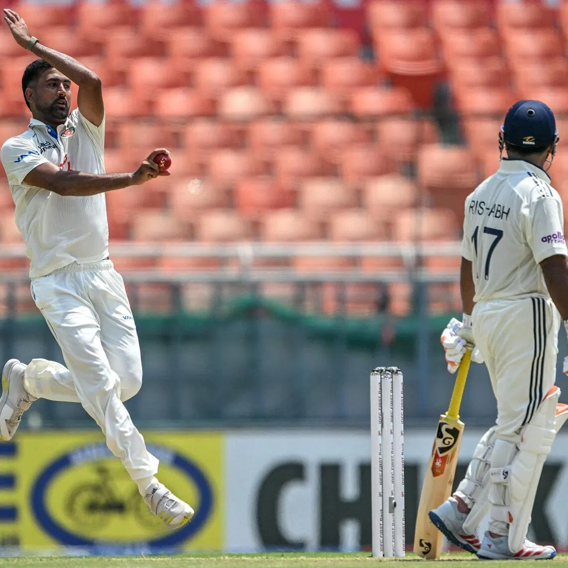 Afghanistan's Mohammad Saleem bowls as India's Rishabh Pant watches on the second day of their only cricket Test at the Maharaja Yadavindra Singh International Cricket Stadium on the outskirts of Chandigarh on June 7, 2026.