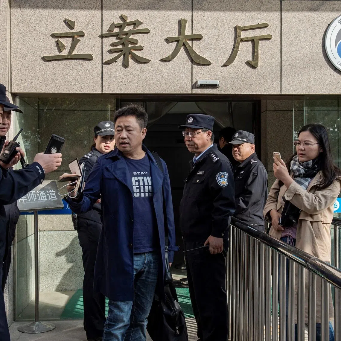 Prominent Chinese human rights lawyer Xie Yang (centre), who has defended Christian and pro-democracy activists, was detained in January 2022. 